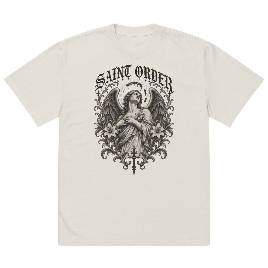 Saint Order Fallen oversized faded-bone tee, front view with winged figure, broken halo, lilies and charcoal botanical artwork.