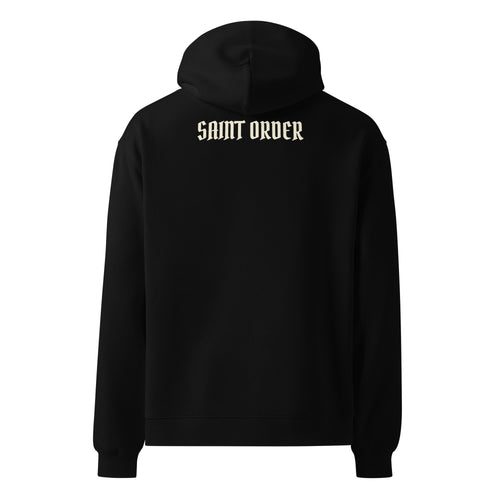 Back of the black Saint Order Eternal relaxed hoodie, with an ivory Saint Order wordmark below the hood.