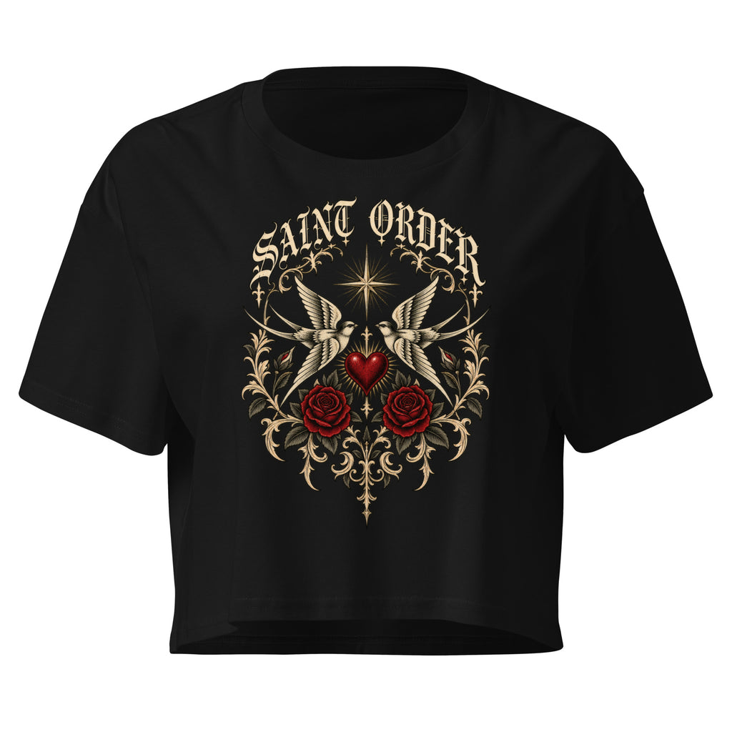 Front of the black Saint Order Mercy crop tee, with ivory swallows, ornamental leaves, roses and a red heart.